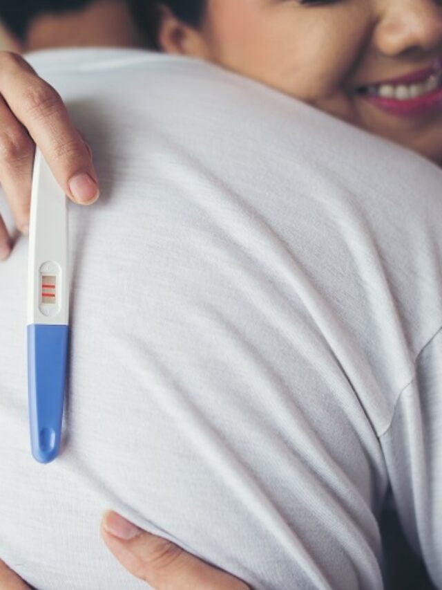 Happy couple smiling after find out positive pregnancy test in b